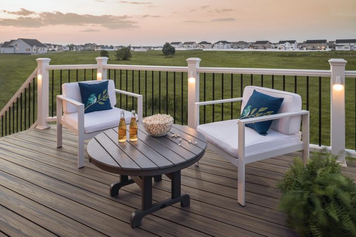 Solar post cap deck lighting at dusk